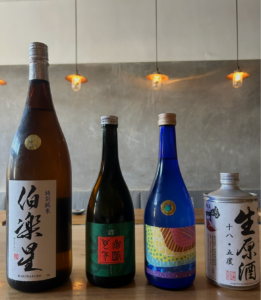 sake bottles lined up on a bar