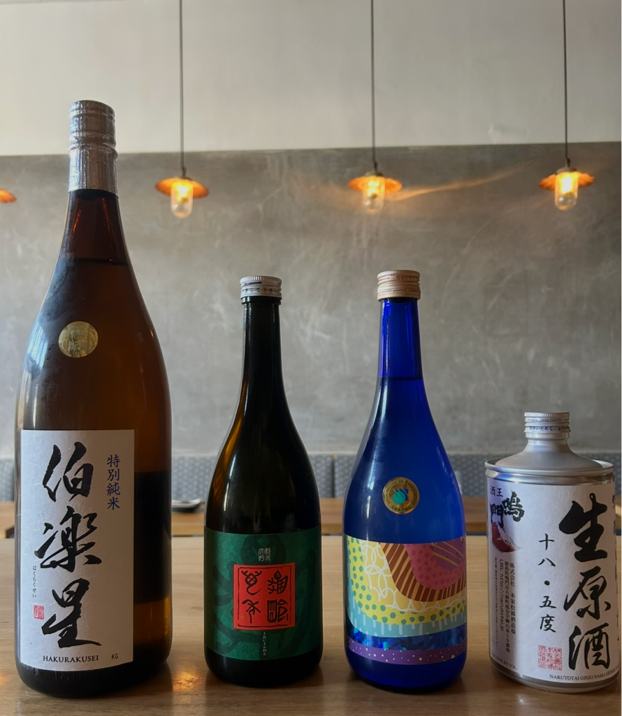 sake bottles lined up on a bar